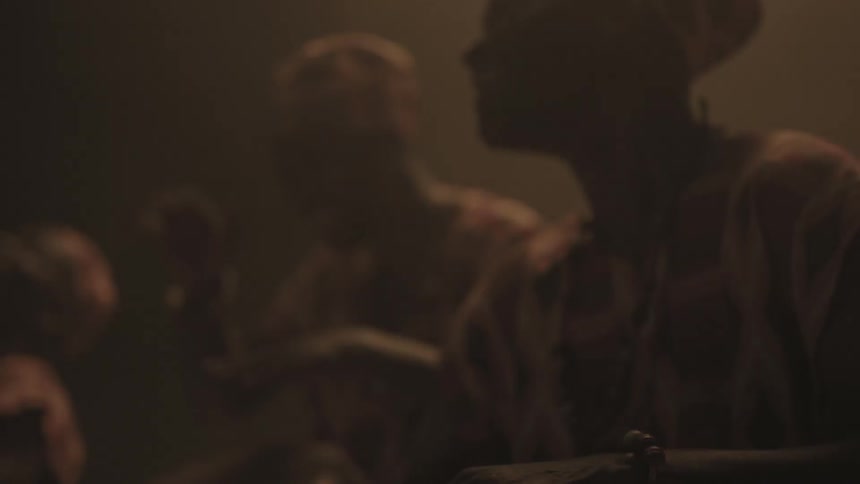 People smiling and playing bongo drums in dim room