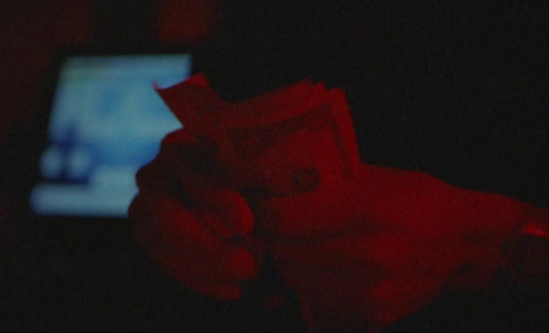 An man counts money at a place of business