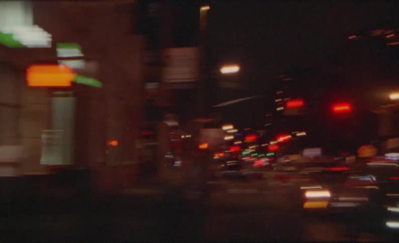 Vehicles fill street on both sides of downtown intersection at night