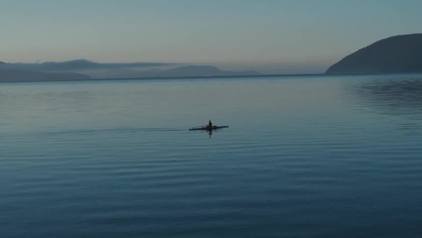 A person is rowing in the large lake