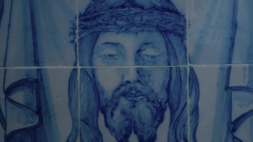 The wall has a portrait of jesus head on it