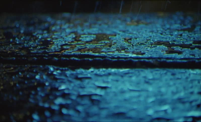 Rain causes puddles on the ground then stops and a shadow passes over