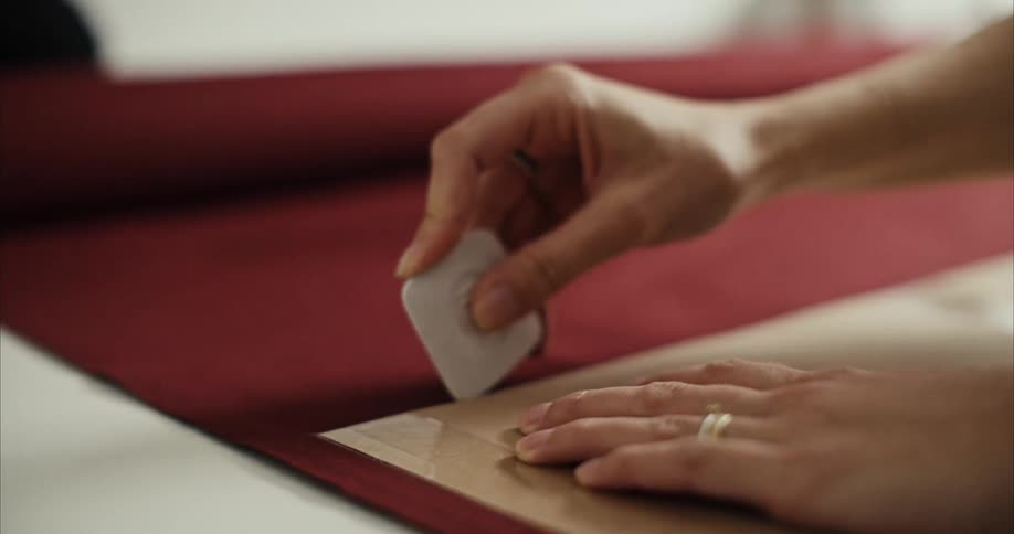 A person is cutting a piece of fabric