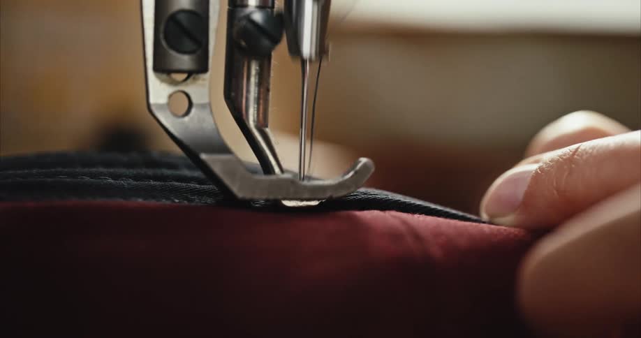 Person lets machine foot walk slowly across fabric as it stitches a seam