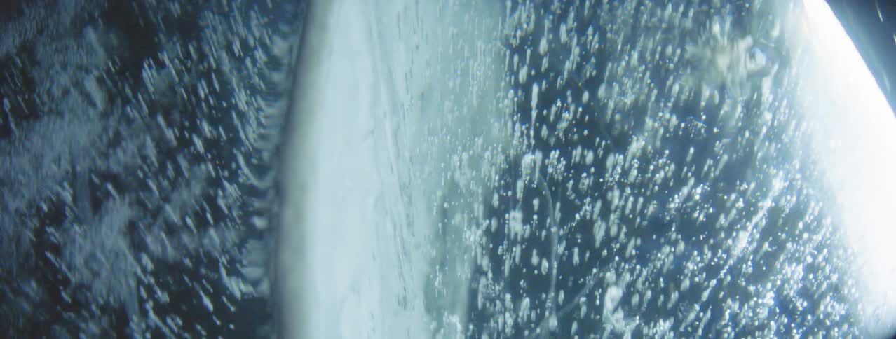 Close up of abstract lighting on icy lake with air Bubbles