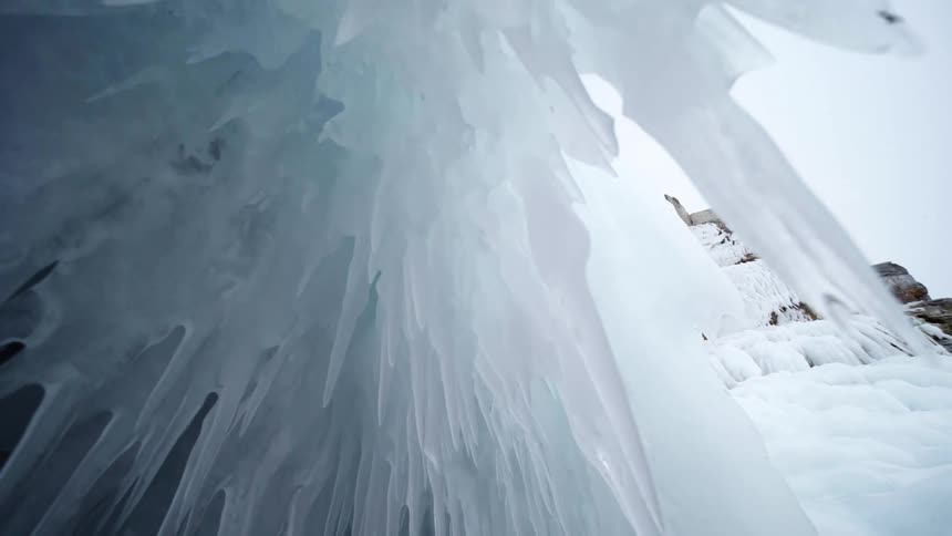 Large icicles hang from the mountain