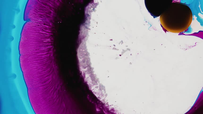 Circular colored shapes that appear to be oil like expand from the center of the image