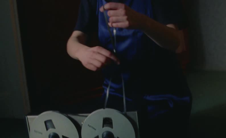 A woman is trying to fix the film reel