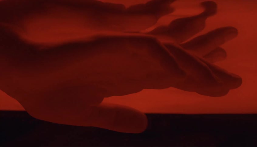 A person puts his hand under water