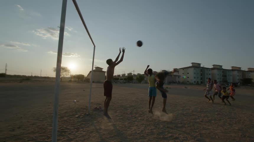 The goalie blocks the soccer ball