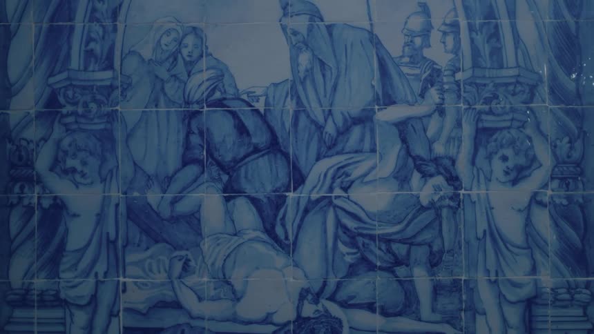 A wall has a painting of people in a group