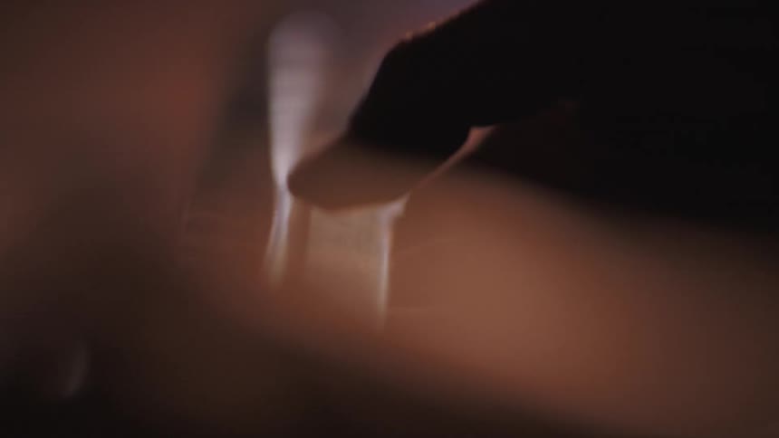 A hand examines a blade