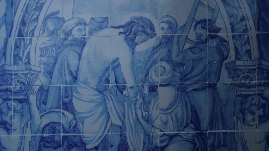 A wall has a painting of people on it