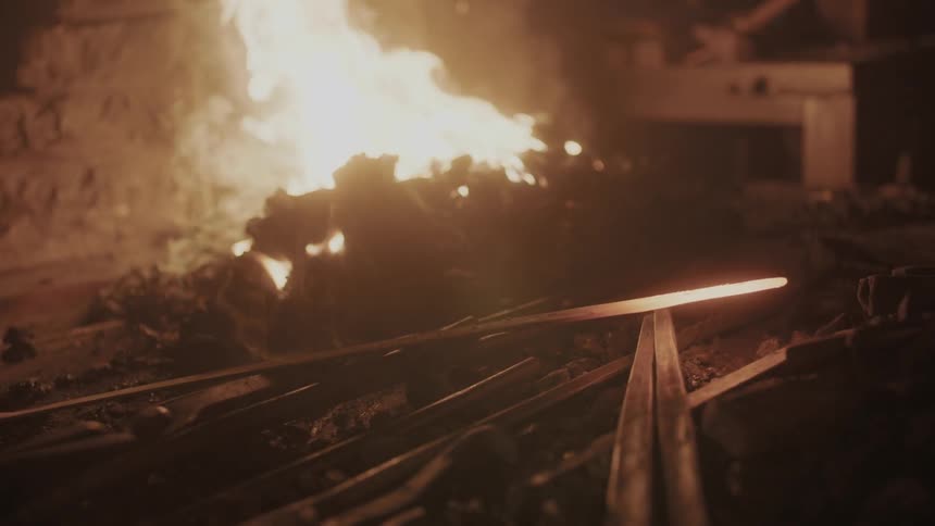 A fire burning in a blacksmith's shop