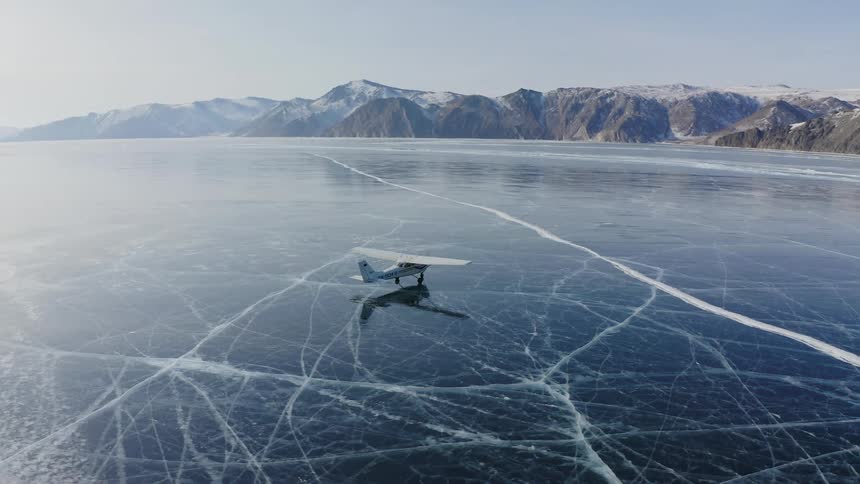 A plane driving on a frozen lake in winter