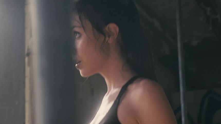 A woman with her hands wrapped does deep squats