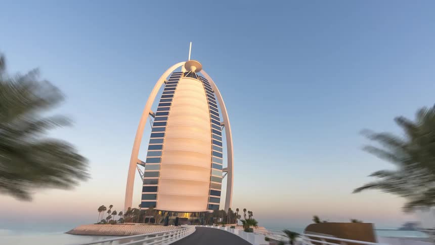 Time lapse of vehicles driving towards a high rise building on the shore