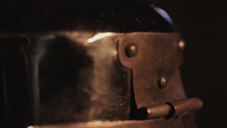 Firelight flickering across metal
