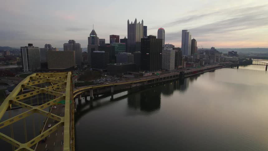 The fort pitt bridge over the allegheny river with pittsburgh city skyline