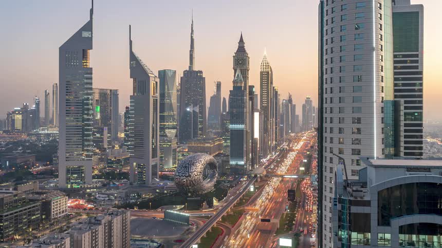 Heavy traffic moves on a freeway through a city as the day progresses