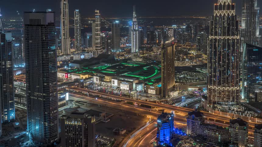 Time lapse of traffic flowing on the streets of the futuristic skyline of dubai at night