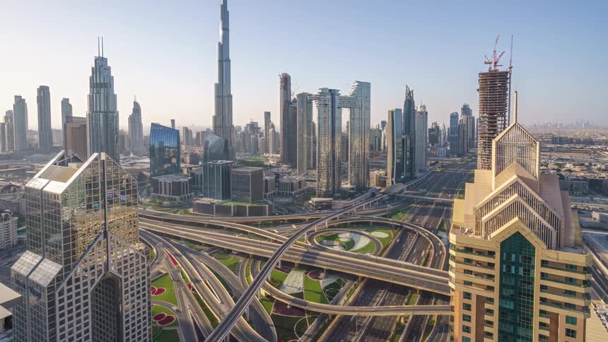 Traffic travels along a large interchange in a metropolis during the day
