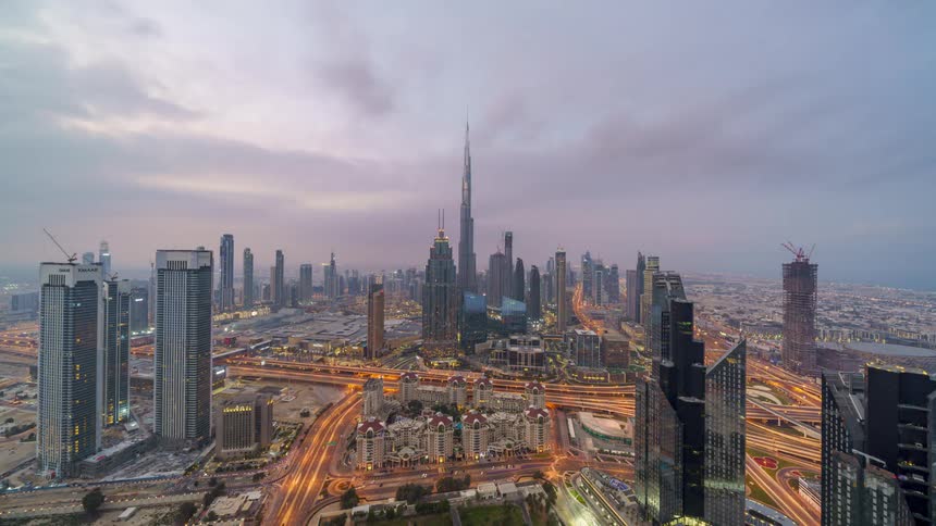 The view is the downtown area and the buildings in the daytime and night time