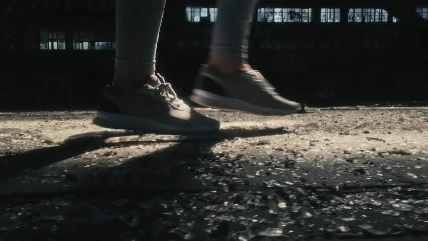 Someone is walking inside of a building in the day time