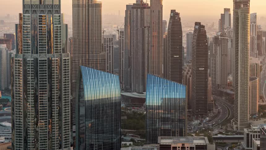 Time lapse of the tall skyscrapers on the skyline of dubai from daylight to night