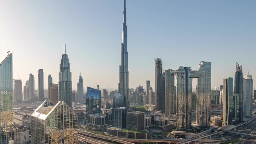 Modern buildings and skyscrapers stand tall over the metropolitan city as traffic moves on the streets