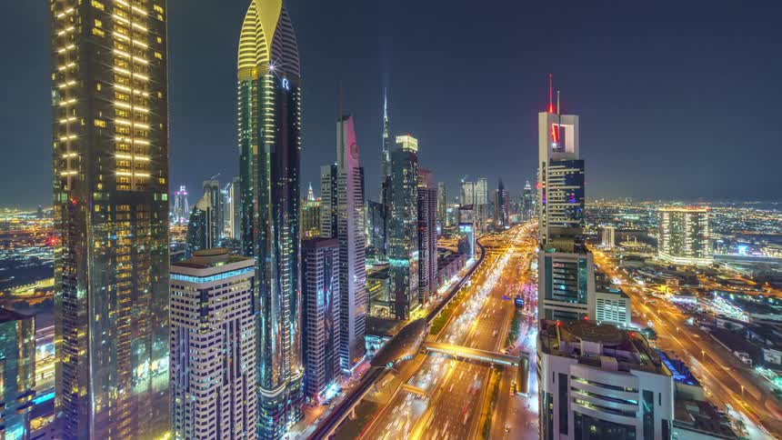 The view is of the downtown area and cars driving on the highway