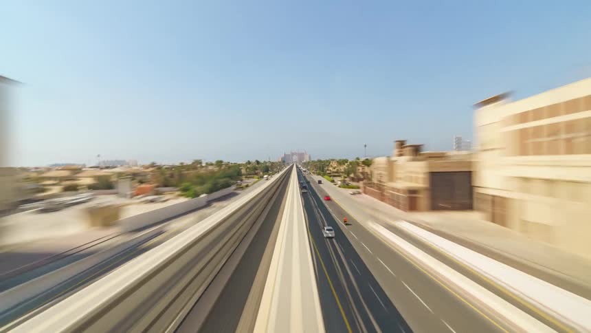 Cars are driving on the road downtown in the middle of the day