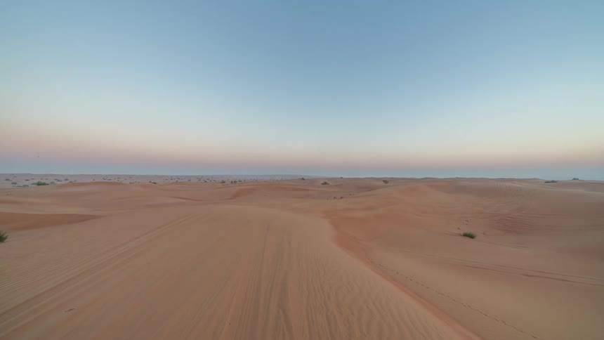 The sun rises over a vast desert