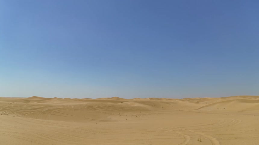Cars are driving off road in a desert area