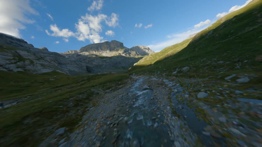 Aerial view of small valley river between high mountains
