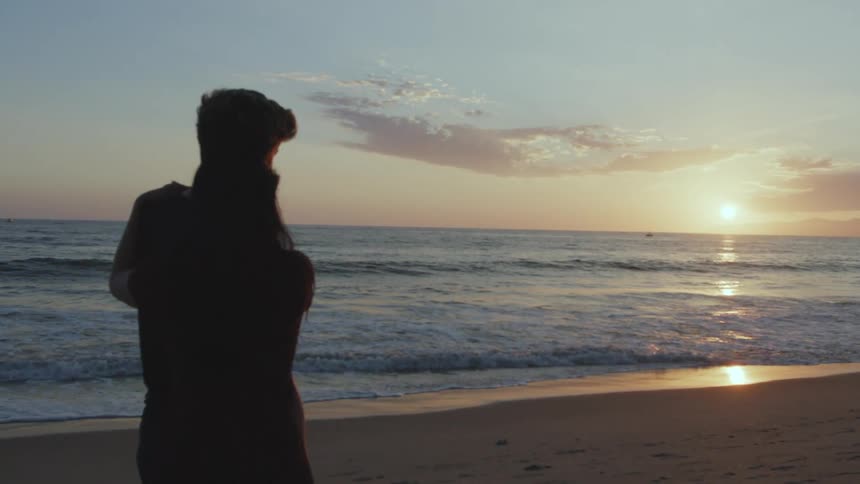 A couple is hanging out together at the beach in the day time