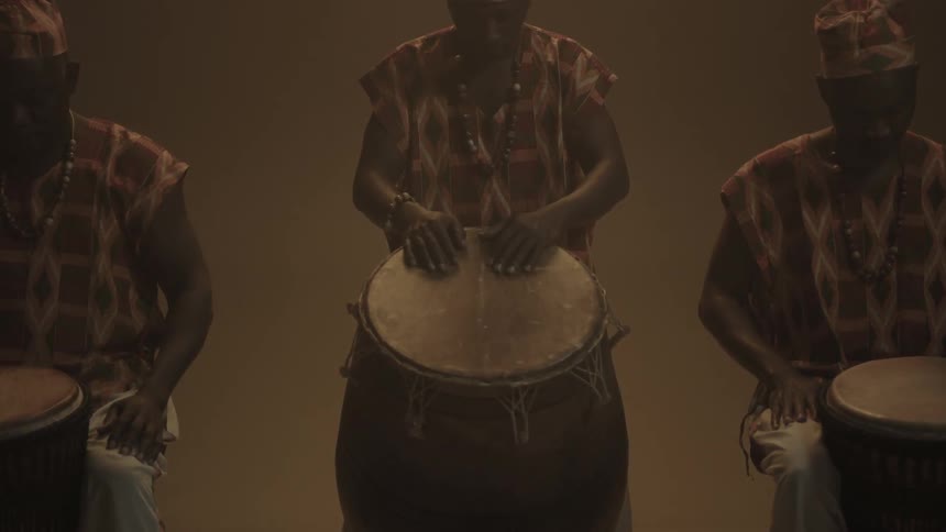 Men posed in front of bongos