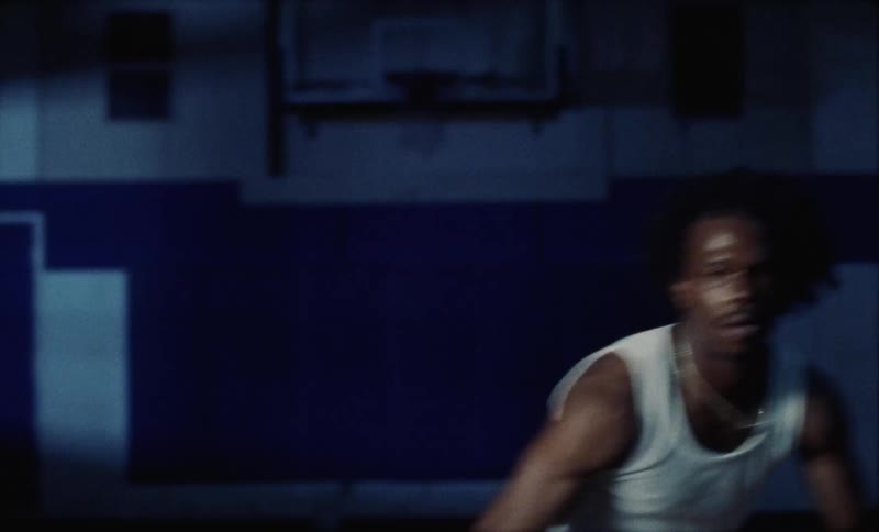 A man dribbles a basketball on the court