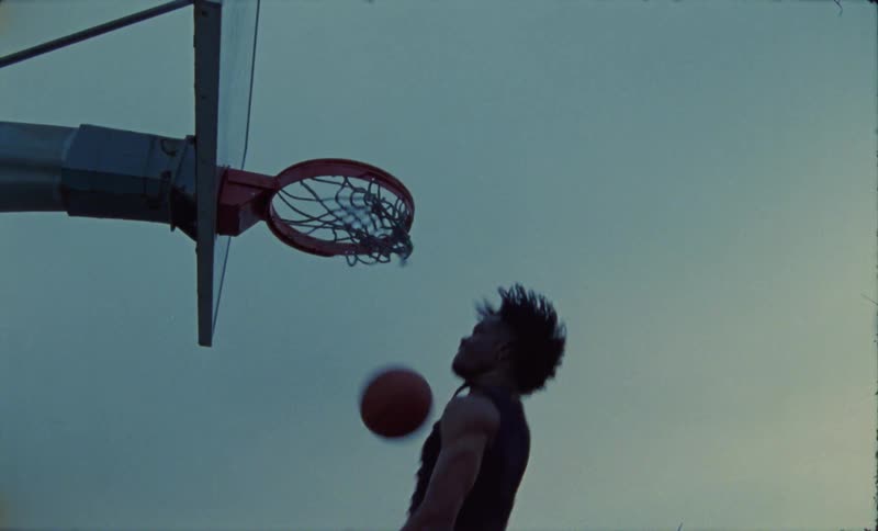 A man jumps and dunks the basketball