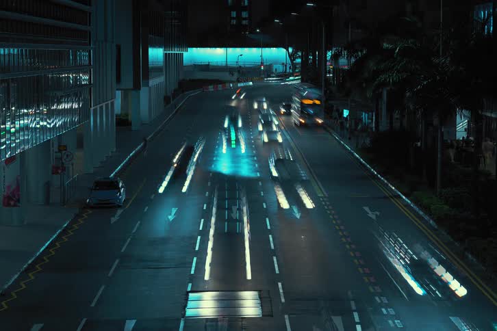 Heavy traffic travels under a bridge and through a downtown tunnel