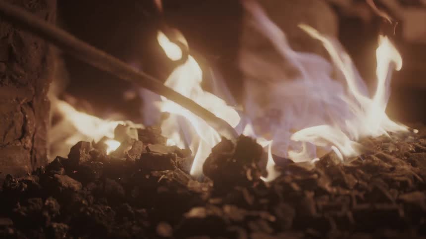 A stick pokes out of the fire