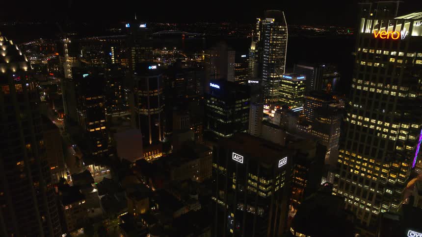 The tall buildings are lit at night
