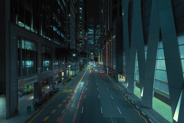 Vehicles streak as they move along city street at night