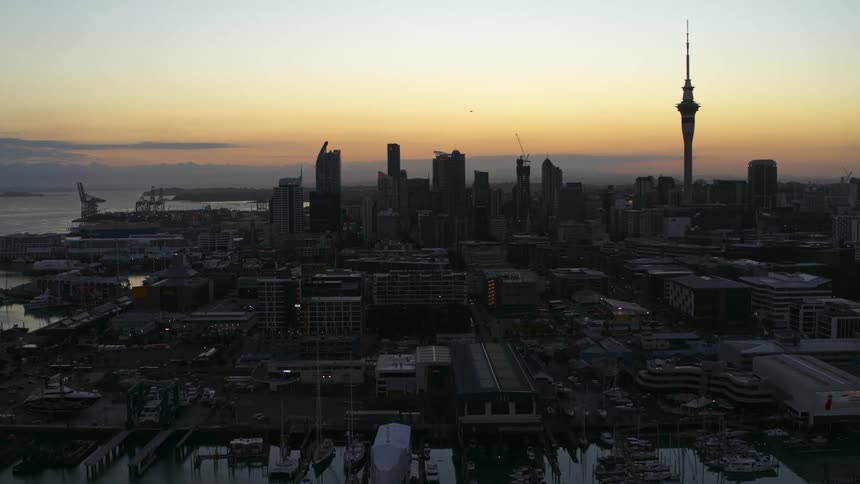 Aerial view of a television transmission tower on the city skyline at evening