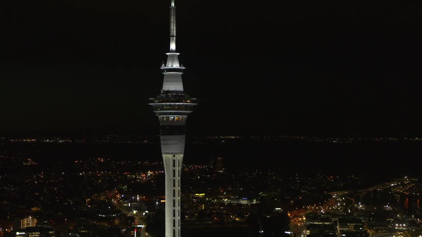 The tall tower rises above the rest of the city