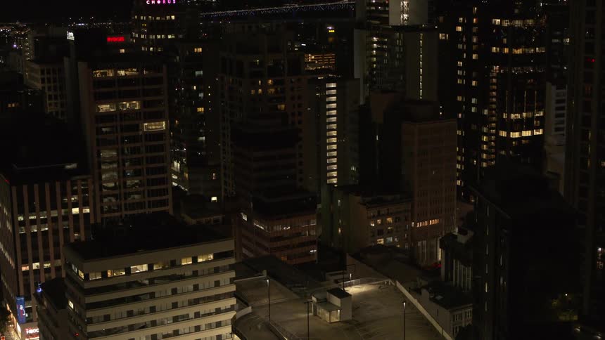 Lights from building interiors and streetlights shine throughout downtown skyscrapers at night