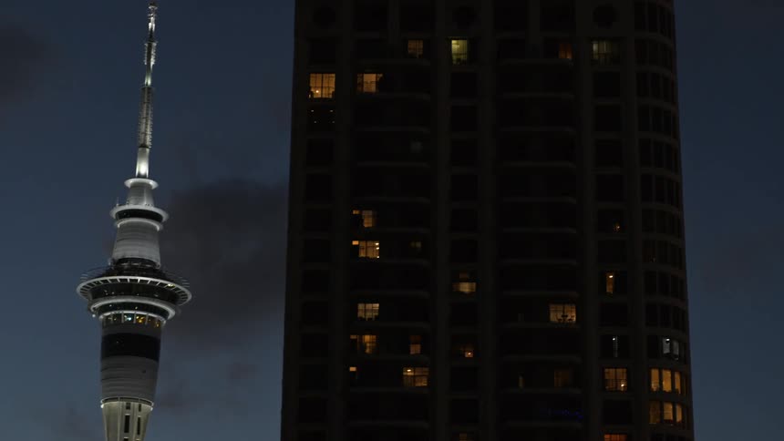 Apartment buildings light up a city sky at night