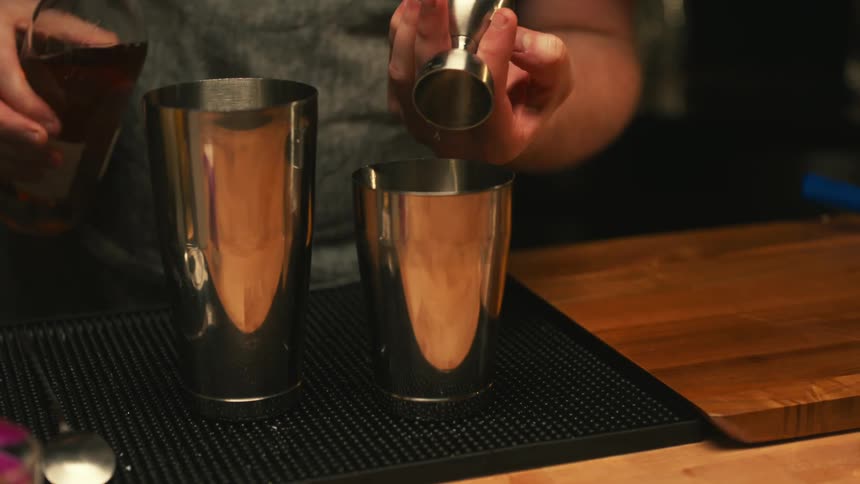 A person preparing an alcoholic beverage