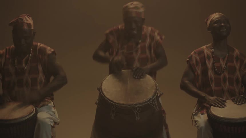 Three men play the drums
