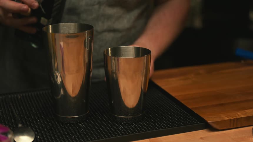 A person is making an alcoholic beverage